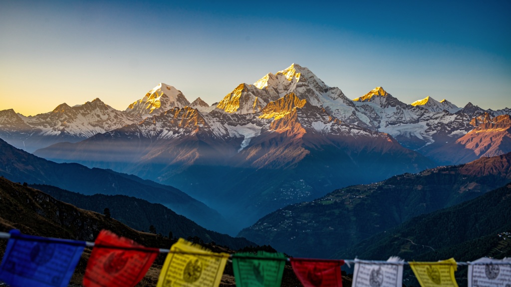 Kanchenjunga mountain range at sunrise seen from Gangtok, with prayer flags in the foreground